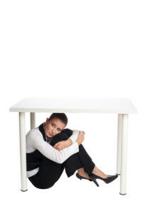 depressed-business-woman-hiding-under-a-table